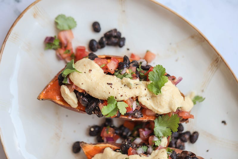 Colorful loaded sweet potatoes ready to eat.