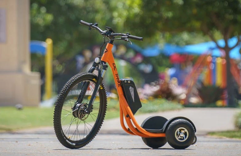 DC Trike in vibrant orange, showcasing its innovative design.