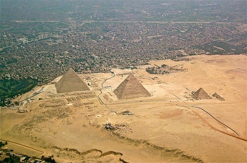 Giza pyramids under the urban skyline