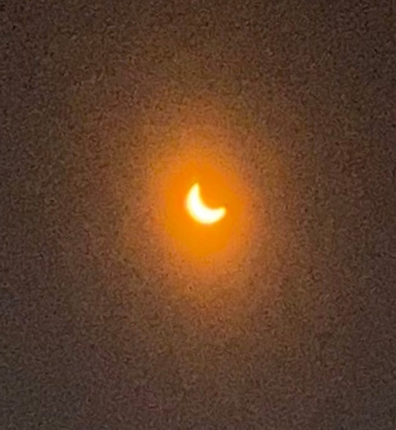 Another angle of the crescent Sun through glasses.