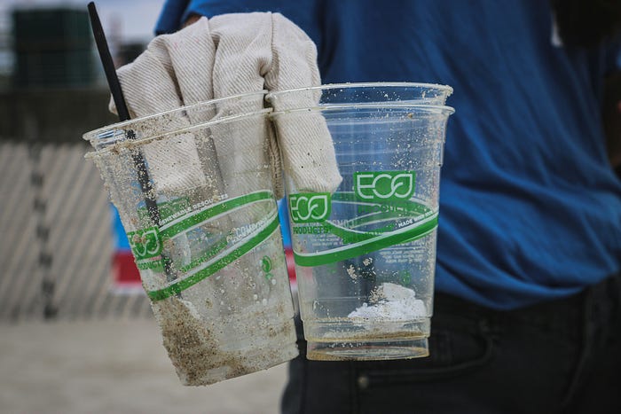 Compostable cup surrounded by nature